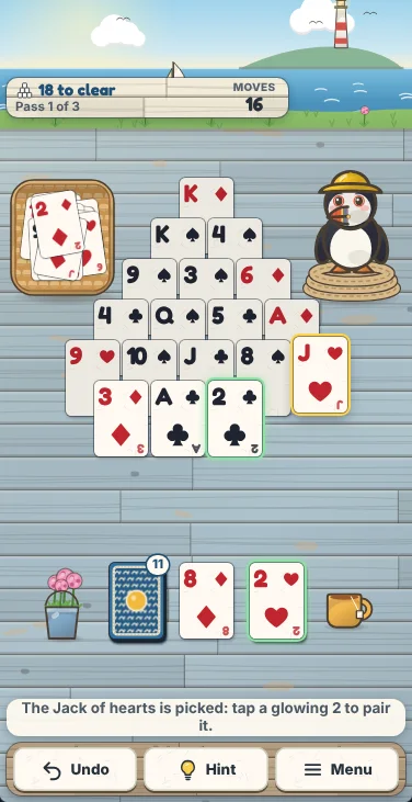 Actual Puffin Bluff Solitaire gameplay on a phone-sized screen: the same position, with the woven tray and Skipper beside the top of the pyramid, the stock, the stock card and the waste in a row below it, and Undo, Hint and Menu on the shelf at the bottom.