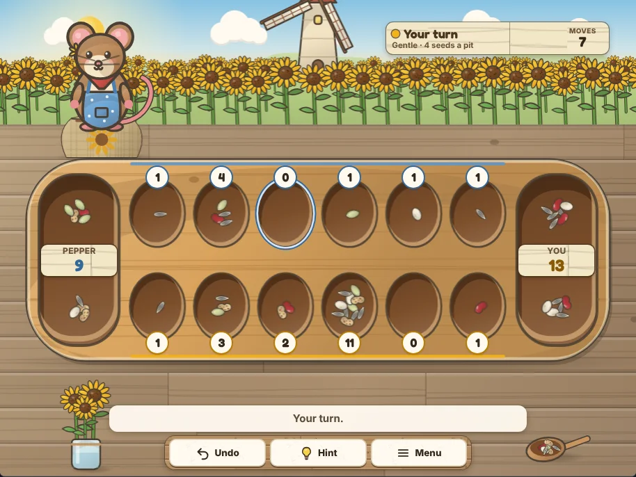 Actual Sunflower Mill Mancala gameplay on a desktop browser: the carved board across a table in a sunflower field, a count badge beside every pit, Pepper’s store on the left and yours on the right with their totals on plaques, Pepper the field mouse on her seed sack above her store, and Undo, Hint and Menu on the shelf below.